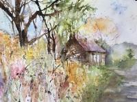 An English lane with banks of flowers and trees leading to a cottage