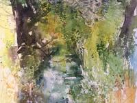 Dappled light in  trees by the water on a fen outside Cambridge