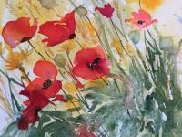 Poppies, cornflowers and wheat saying together in the field