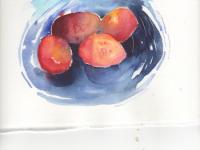 Four plums in a bright blue dish