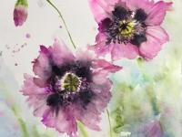 Two mauve poppies in full bloom with a bud againstagreen/blue background