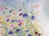 Two butterflies exploring the cornflowers