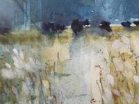 Blue sky with distant dark blue trees with water edged with slivery reeds