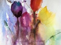 Purple, red and yellow tulips againsta blue background