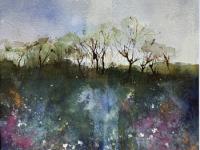 A tree lined horizon overlooking water and pink/mauve flowers