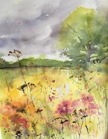 Meadow flowers and grasses with bank of distant trees and large tree 