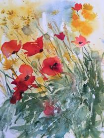 Poppies, cornflowers and wheat saying together in the field