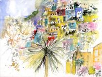 Colourful houses on the hillside, trees and church in forefround