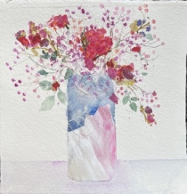 Pink flowers and gypsophila in a blue and pink vase